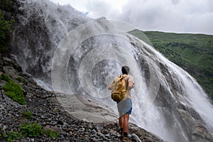 Waterfall Landscape and male Traveler enjoying waterfall view
