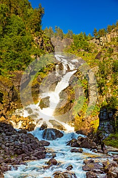 Waterfall Latefossen at sunset lights in summer, Norway