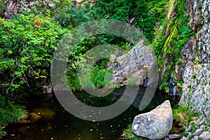 Waterfall in Manteigas Town, Serra da Estrela or Mountain of Star in Portugal called Poco do Inferno or Hell Pit