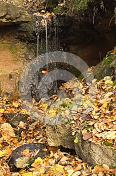 Waterfall at mara`s chambers in autumn day, Latvia photo