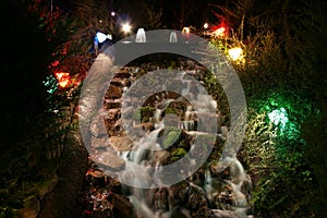 A waterfall on a minuature golf course at night