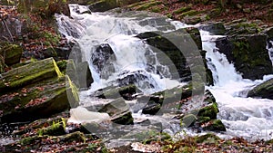 Waterfall in misty autumn forest