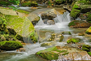An Waterfall with Moss Covered Rocks