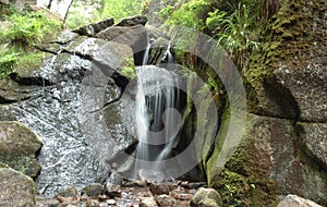 Waterfall and a moss-grown stone