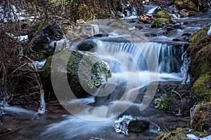 Waterfall in a mountain forest in winter