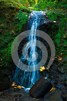 A waterfall in mountain range autumn