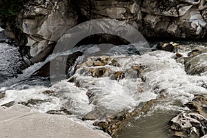 Waterfall in the mountain river with big rocks. Travelling in quarantine period. Nature landscape. Karpathians mountains