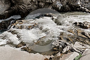 Waterfall in the mountain river with big rocks. Travelling in quarantine period. Nature landscape. Karpathians mountains