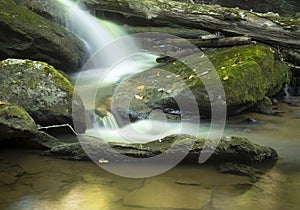 Waterfall near Boone in North Carolina coursing through boulders and over a log