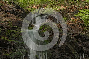 Waterfall near Kouty nad Desnou village in summer day