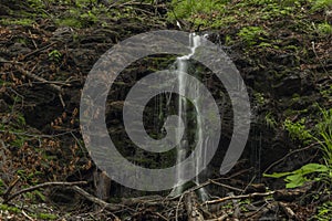 Waterfall near Kouty nad Desnou village in summer day