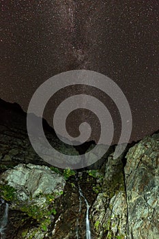 Waterfall at night with starry sky