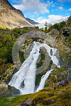 Waterfall Norway with glacier in background