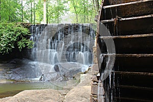 Waterfall with old mill wheel