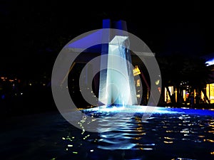 Waterfall at an open street mall with blue lighting