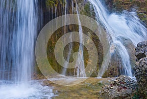 waterfall over a hure stone on mountain river