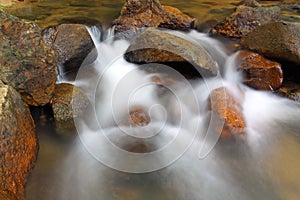 Waterfall over natural rocks