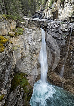 Waterfall over a Rock Cliff in the Canadian Rocky Mountains