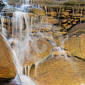 Waterfall over rocks in nature park