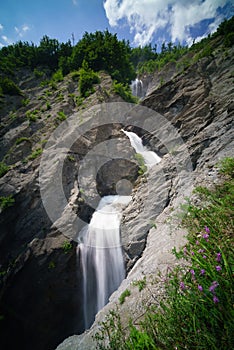 Waterfall over a sandy slope