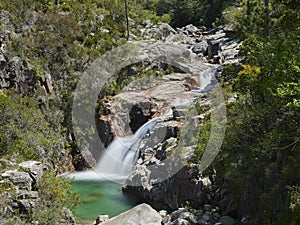 Waterfall of portela do homem running to green lake photo