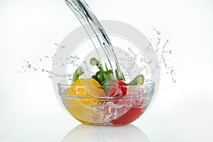 Waterfall pouring onto a glass bowl with peppers