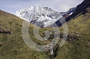 Waterfall and Quitaraju mountain peak located in the Cordillera