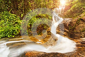 Waterfall in rainforest with sunray