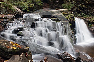 Waterfall at Ricketts Glen State Park in Autumn with beautiful leaves in foreground