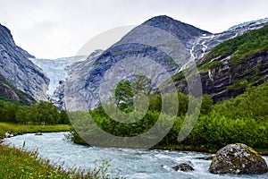 Waterfall and river from Briksdalsbreen Briksdal glacier. Jostedalsbreen National Park. Norway