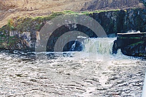 Waterfall on the river, discharge of water on the dam