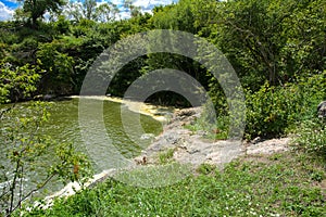 The waterfall on the river flows through and over the rocks cove