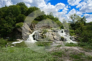 The waterfall on the river flows through and over the rocks cove