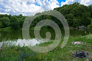 The waterfall on the river flows through and over the rocks cove