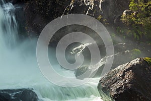 waterfall between rocks at sunrise