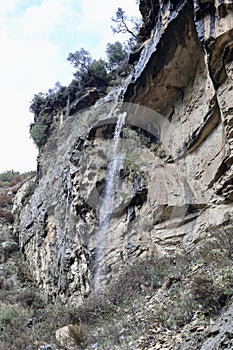 Waterfall rocky cliff