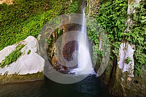 Waterfall in rocky grot