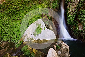 Waterfall in rocky grot photo