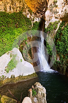 Waterfall in rocky grot photo