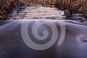 Waterfall in several stages and fallen leaves