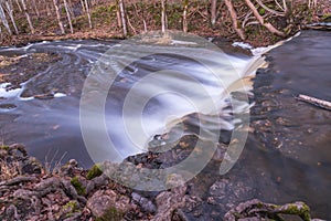 Waterfall in several stages and fallen leaves