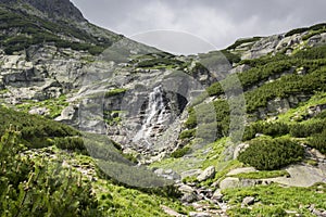 Waterfall Skok in Valley in High Tatras, Mlynska Dolina, wild slovakia mountains with touristic trail