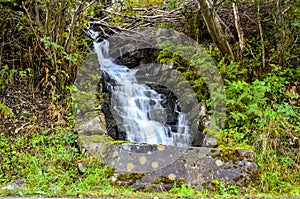 Waterfall with smooth water in autumn