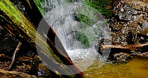 Waterfall splash, spring water as it falls and dribbles on rocks covered