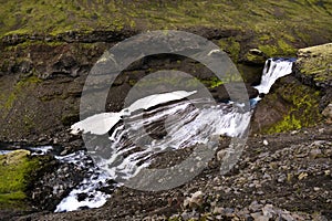 Waterfall spread over a rock, seen on FimmvÃ¶rduhals mountain pass, Iceland