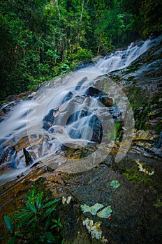 Waterfall stream down, flowing in the tropical rainforest