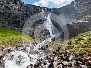Waterfall and stream flowing on mountainside