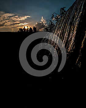 Waterfall and sunset view with friends