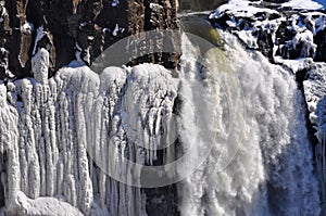 Waterfall Surrounded by Icicles in the Winter