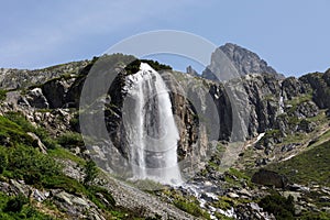 Waterfall at the Susten pass located in Switzerland in winter during daylight